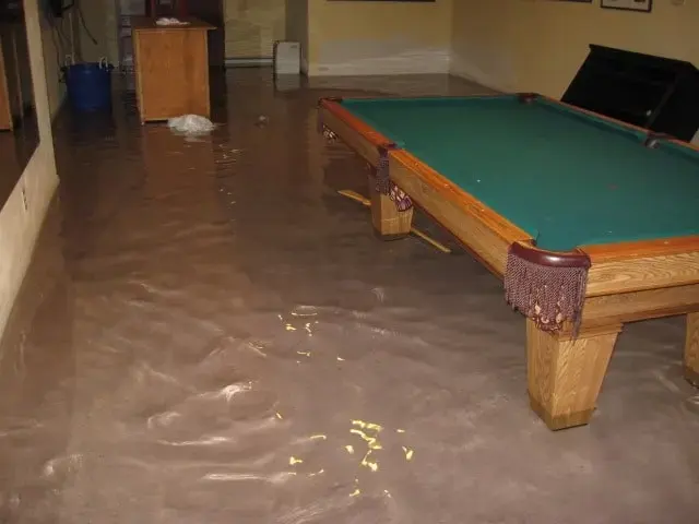 Standing water across a finished basement rec room